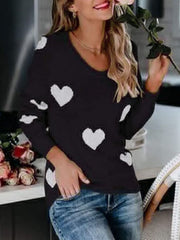 Black acrylic sweater with white heart pattern, long sleeves, and V-neck.