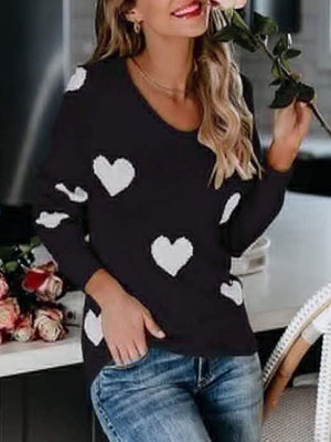 Black acrylic sweater with white heart pattern, long sleeves, and V-neck.