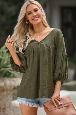 Army green textured gauze blouse with gathered V-neck and balloon sleeves.
