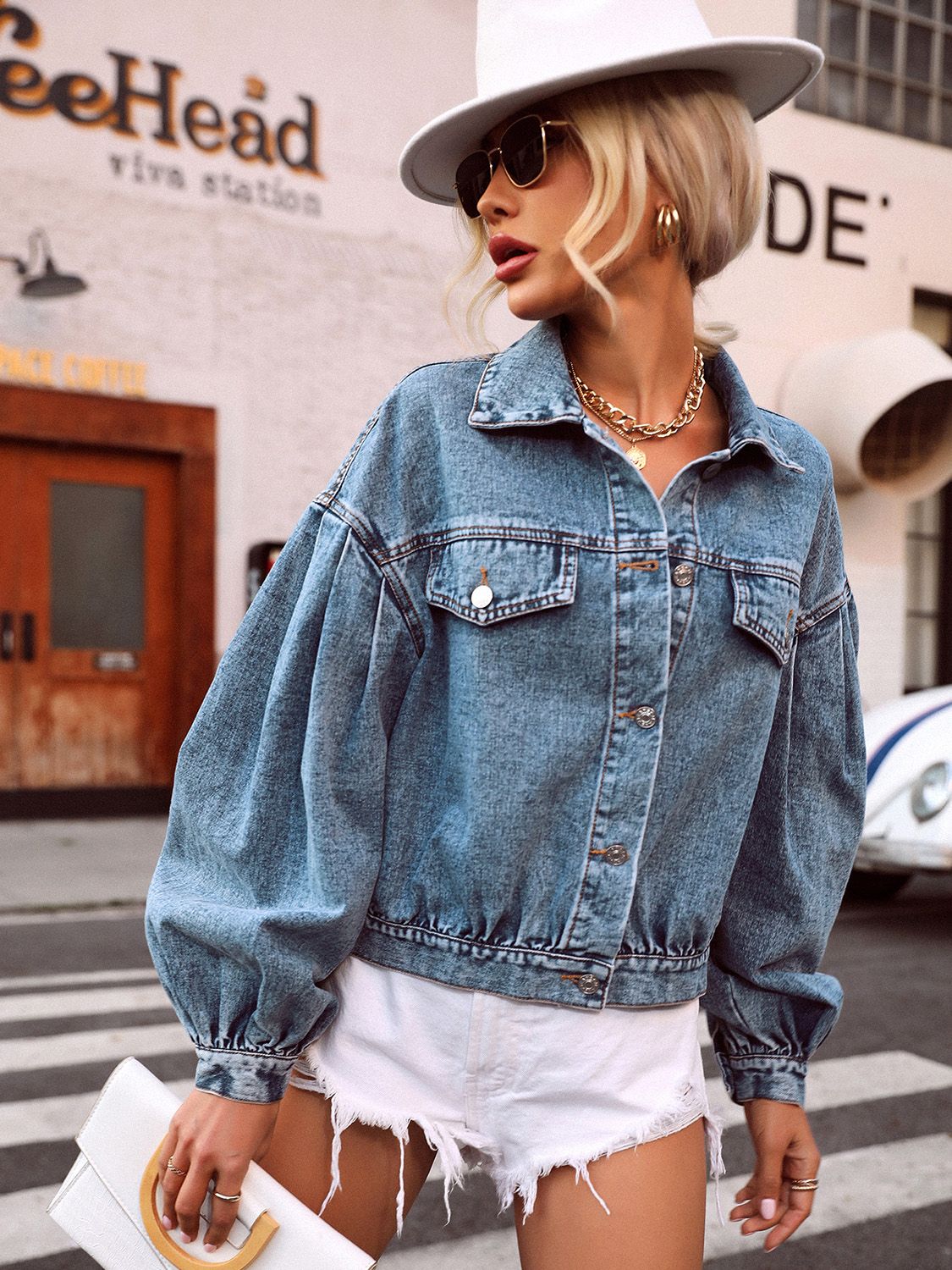 Balloon sleeve denim cropped jacket in medium wash with collared neckline and buttoned front.