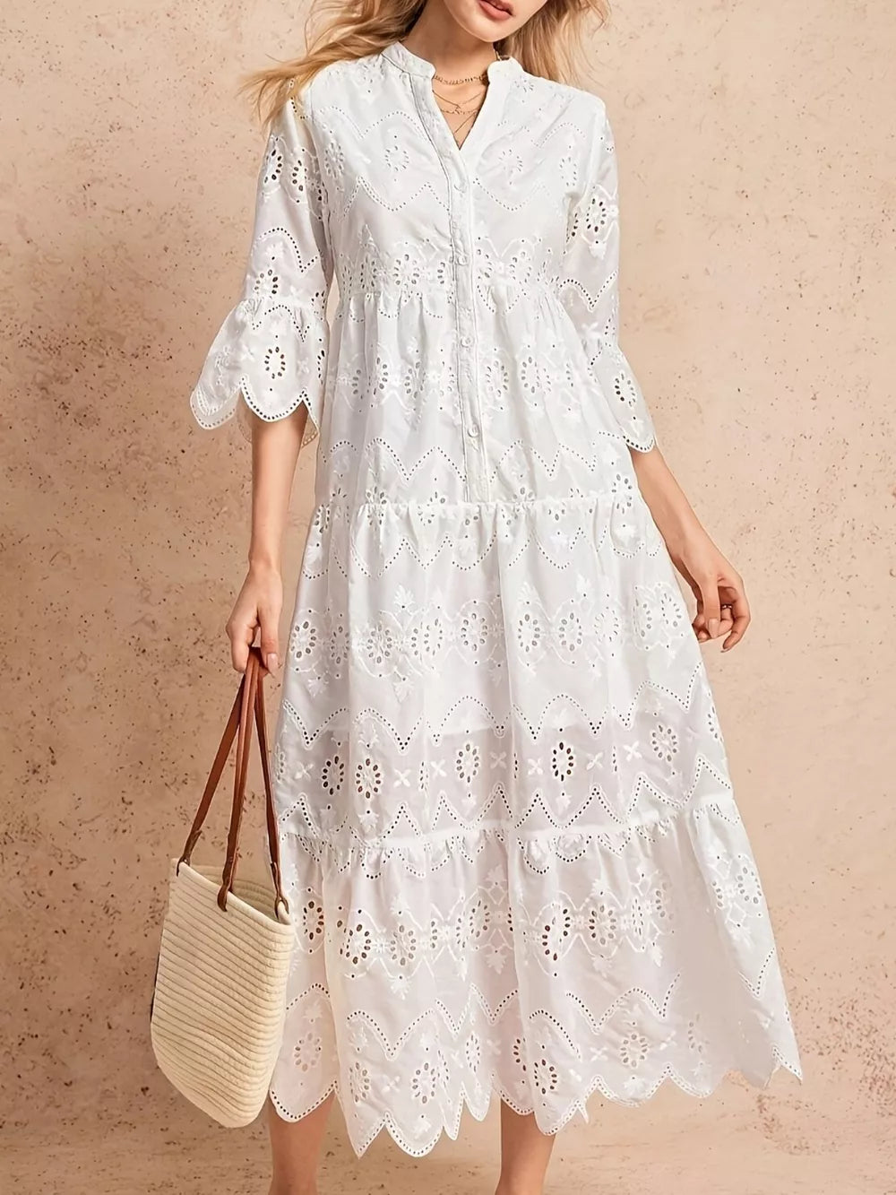 White eyelet tiered midi dress with button front and bell sleeves.