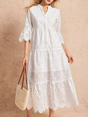 White eyelet tiered midi dress with button front and bell sleeves.