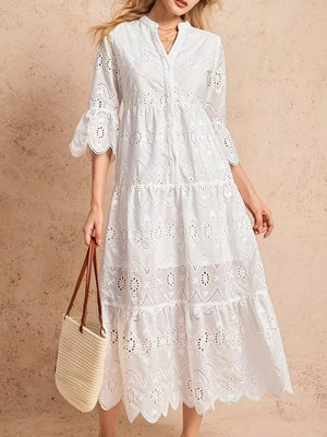 White eyelet tiered midi dress with button front and bell sleeves.