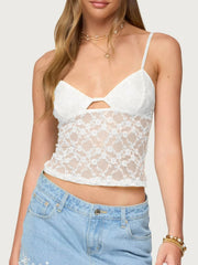 White floral lace cami with adjustable straps and cutout detail.