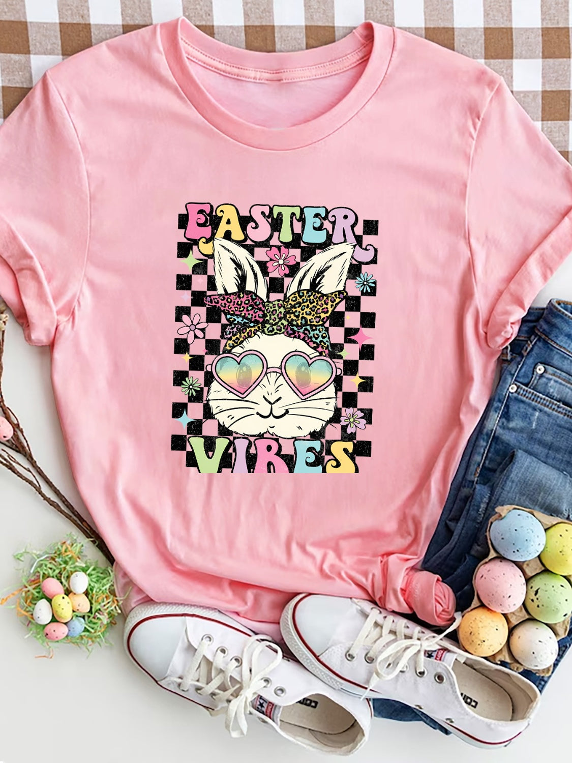 Blush pink graphic tee with Easter bunny wearing heart sunglasses and bandana, 100% polyester.