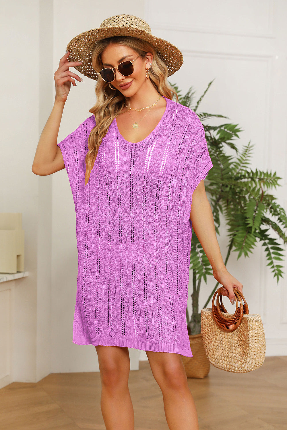 Pink knit swim dress with slit sleeves and a V-neck, featuring a textured pattern.