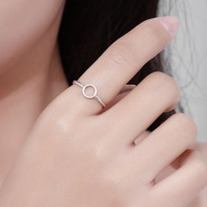 Sterling silver minimalist circle ring on a woman's finger.