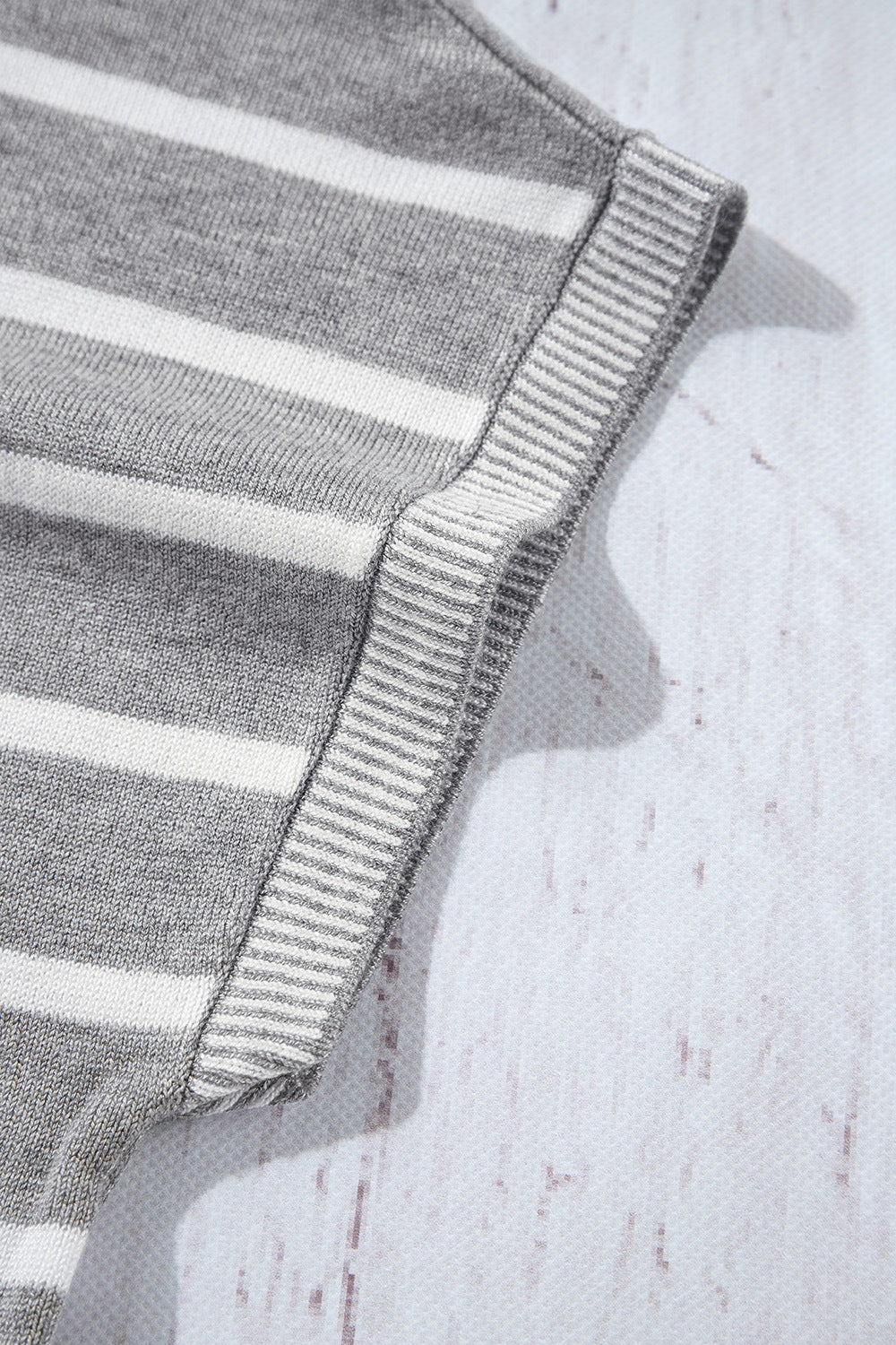 Light gray and white striped knit t-shirt with contrast ribbed trim detail.