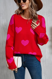 Red acrylic sweater with pink intarsia hearts, crew neck, long sleeves.