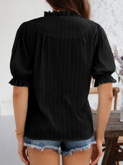 Black textured puff sleeve blouse with ruffled neckline and cuffs.
