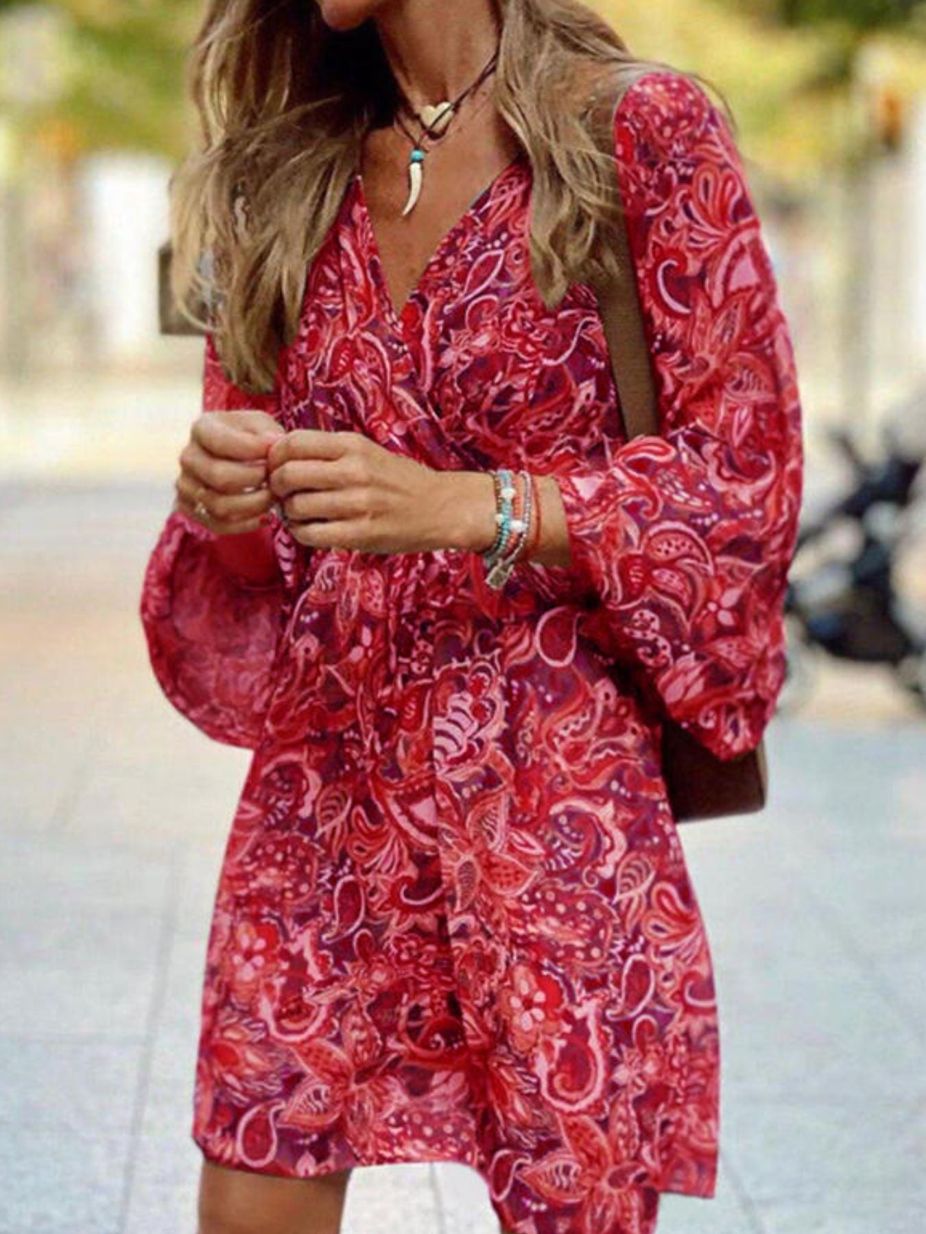 Red paisley print wrap dress with balloon sleeves and a V-neck.