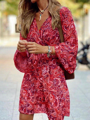 Red paisley print wrap dress with balloon sleeves and a V-neck.