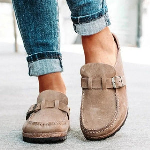 Suede buckle mule loafers in caramel with contrast stitching and adjustable strap.