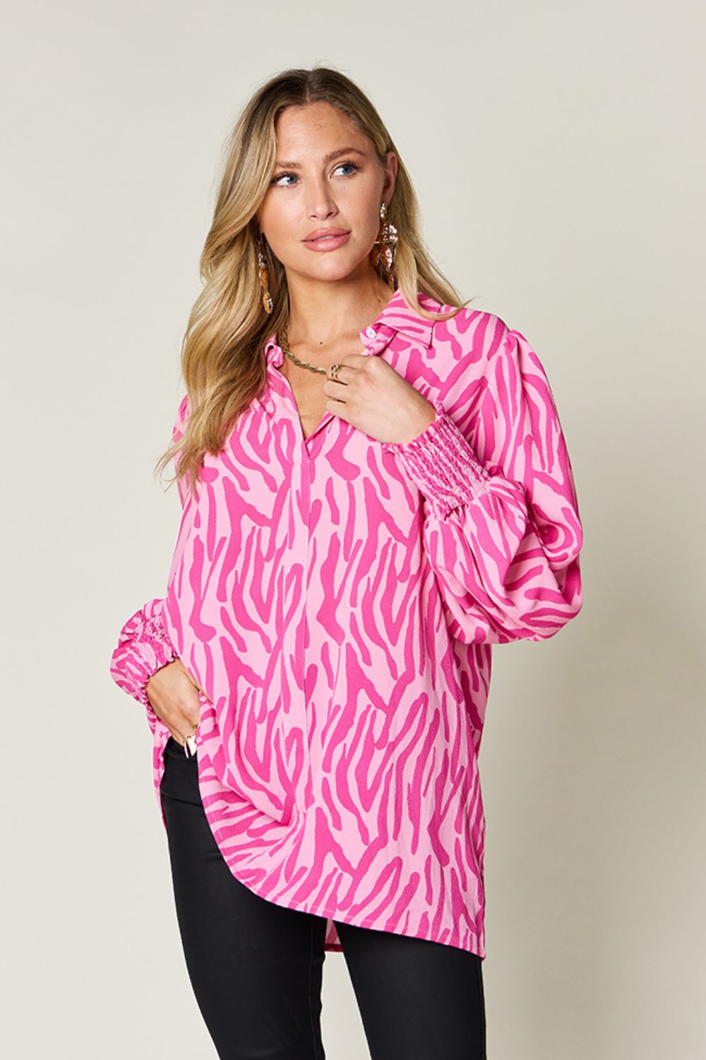 Pink zebra print blouse with shirred cuffs and balloon sleeves.