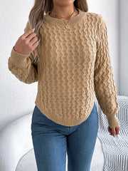 Camel knit sweater with textured cable pattern and asymmetric hem.