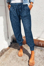 Peacock blue leopard print drawstring trousers with a relaxed fit and cuffed ankles.