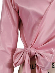 Blush pink satin blouse with draped front and large bow detail at waist