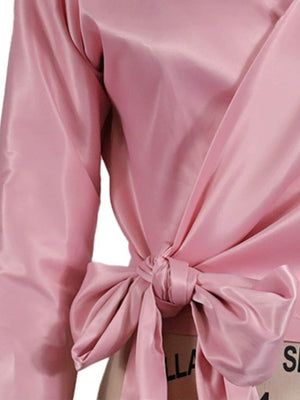 Blush pink satin blouse with draped front and large bow detail at waist
