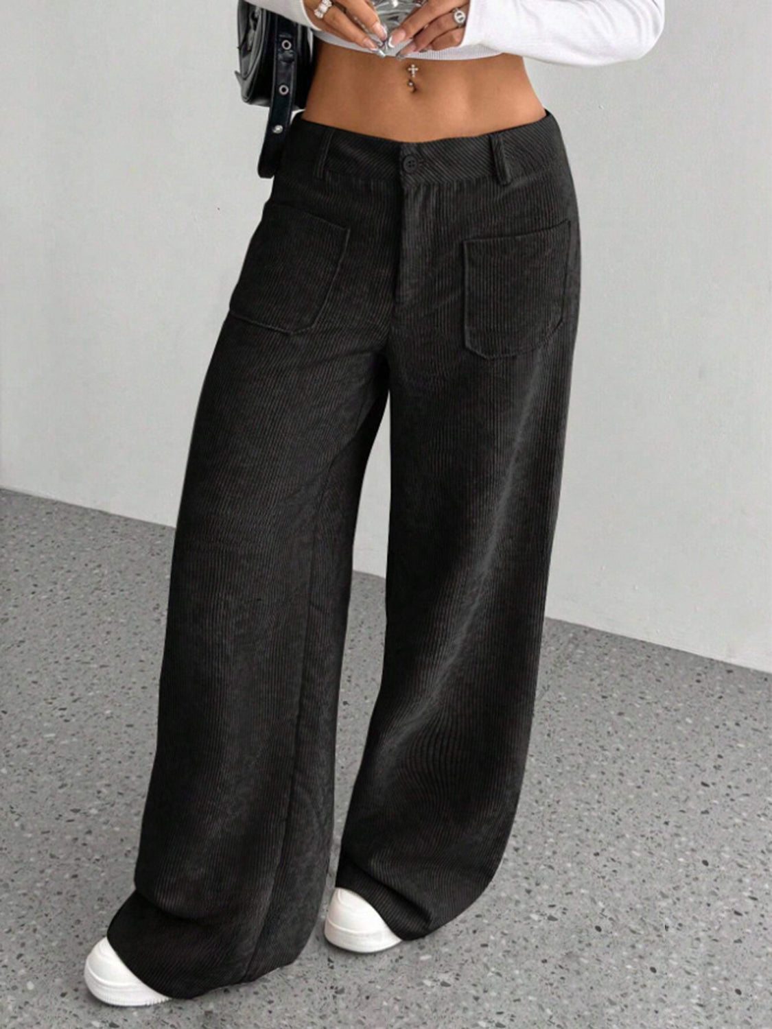 Black corduroy wide-leg utility trousers with front patch pockets.