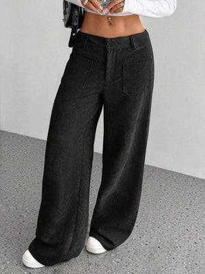Black corduroy wide-leg utility trousers with front patch pockets.