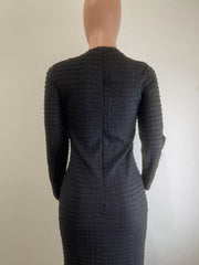 Black textured midi dress with crew neck and decorative buttons, body-hugging cut.