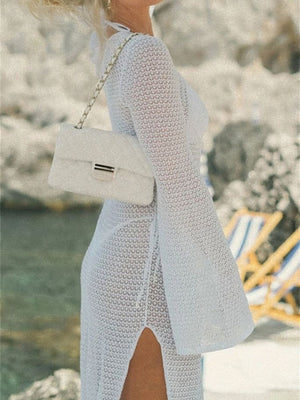 White crochet maxi dress with bell sleeves and side slit, 100% polyester.