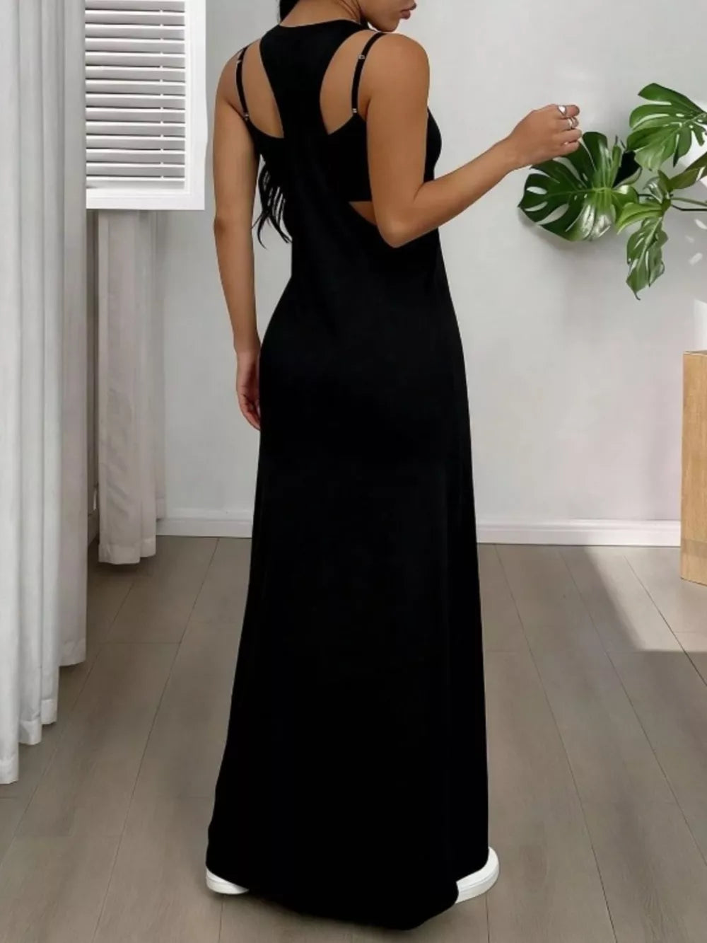 Black scoop neck cami maxi dress with cutout back detail and adjustable straps.