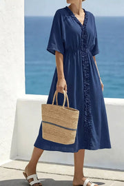 Blue cotton midi dress with ruffled V-neck and elastic waist.