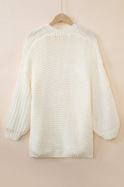 Cream textured knit cocoon cardigan with balloon sleeves and ribbed cuffs.