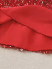 Red baby dress with star-print tulle hem and pom-pom details