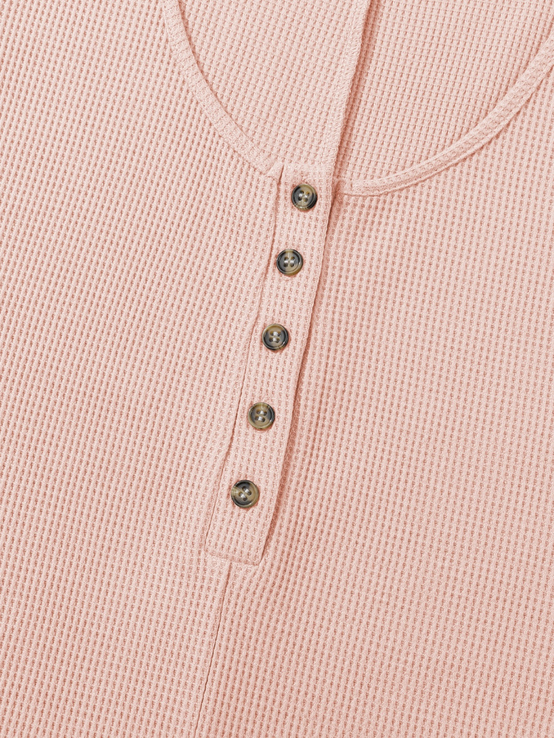 Blush pink waffle knit button-down romper with henley neckline and tortoise buttons.
