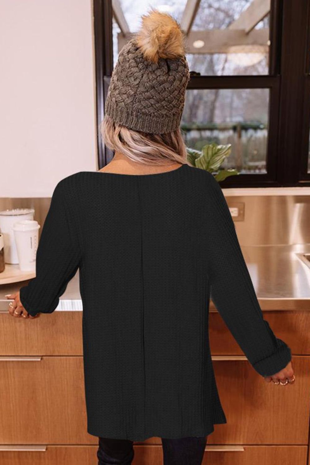 Black waffle knit tunic with boat neck and long sleeves.