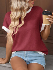Textured knit short-sleeve t-shirt in wine red with white trim, worn with denim shorts.