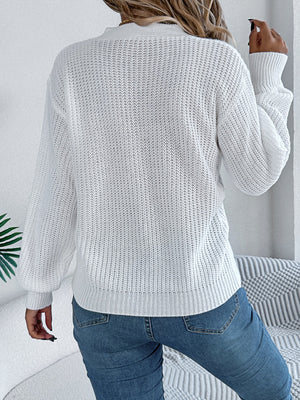 White cable knit sweater with crew neck and long sleeves, casual acrylic knit.