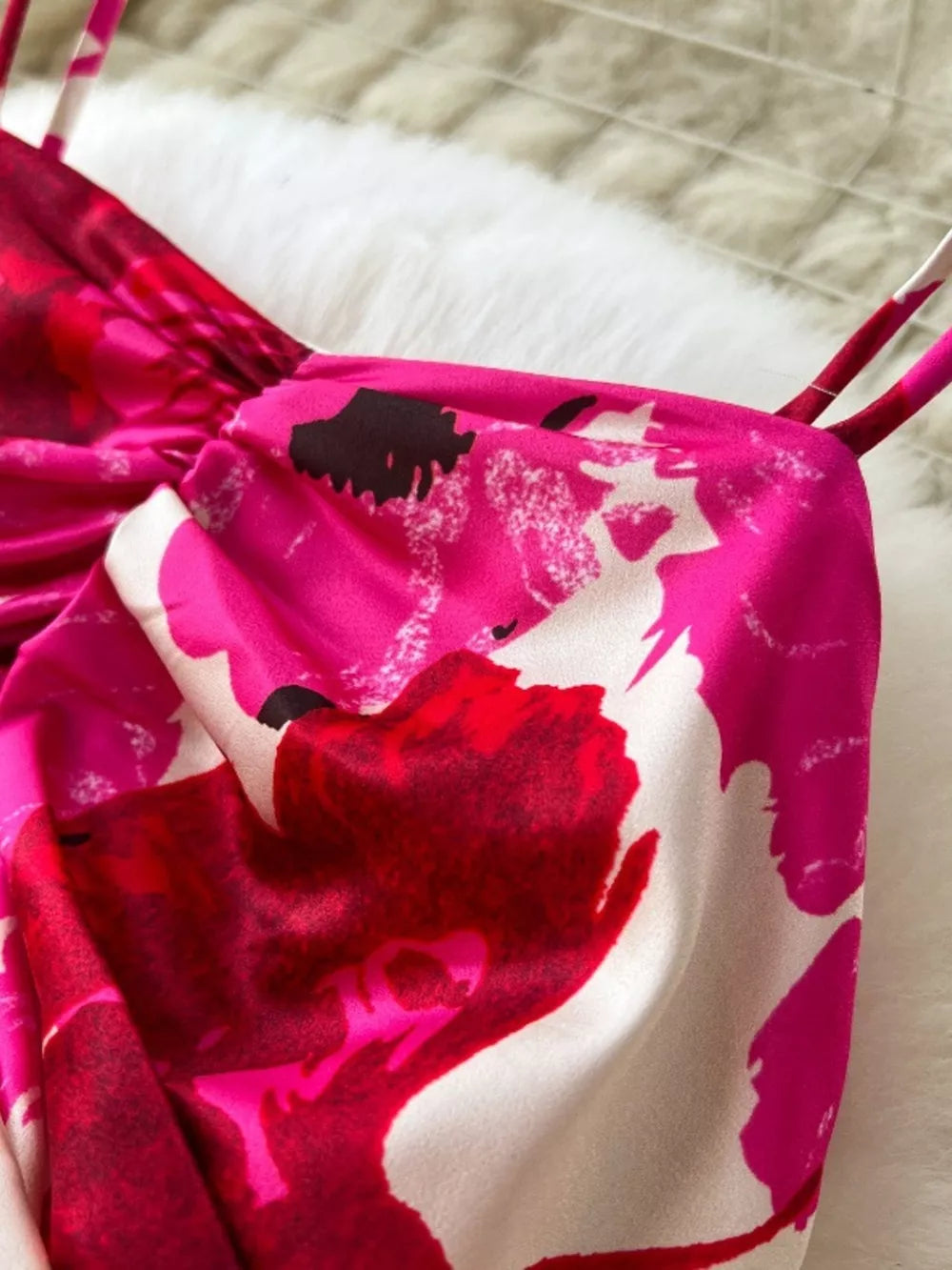 Vibrant floral tiered cami dress with ruched detail and thin straps.