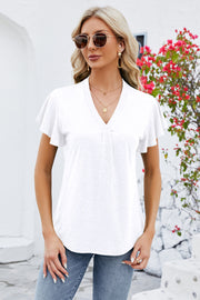 White V-neck blouse with pleated front and flutter sleeves