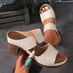Ivory quilted leather platform mules with block heel and open toe.