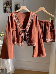 Brown embroidered tie-front top with bell sleeves and matching shorts set.