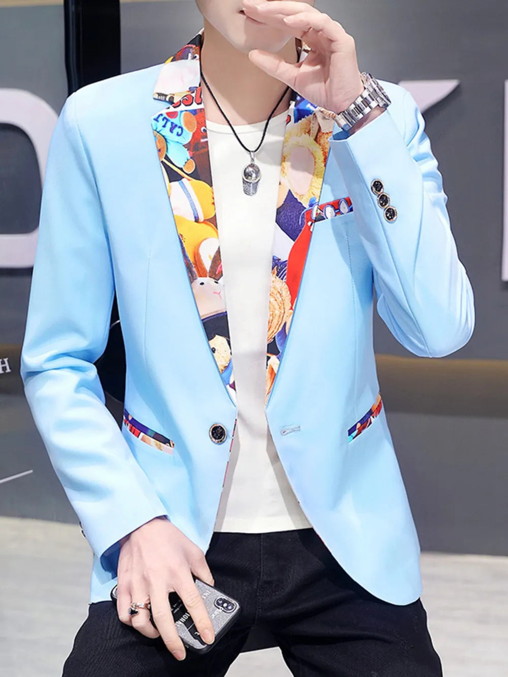 Men's blue slim fit blazer with vibrant printed lapel trim and pocket detail.