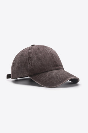 Washed cotton baseball cap in brown with adjustable strap and stitched details.