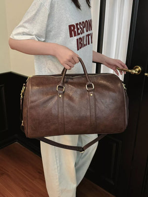Classic large brown pu leather travel bag with detachable strap and gold hardware.