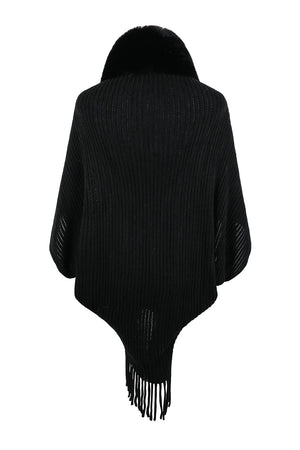 Black knit cape with faux fur collar and fringe hem
