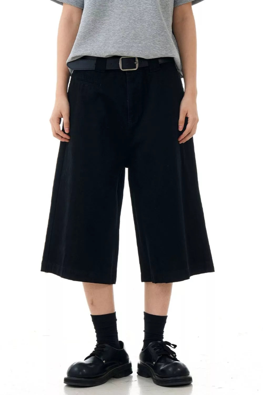 Black relaxed fit bermuda shorts with belt loops and pockets.