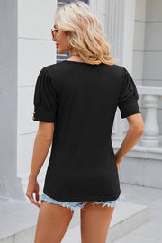 Black gathered sleeve tee with gold button detail on cuffs