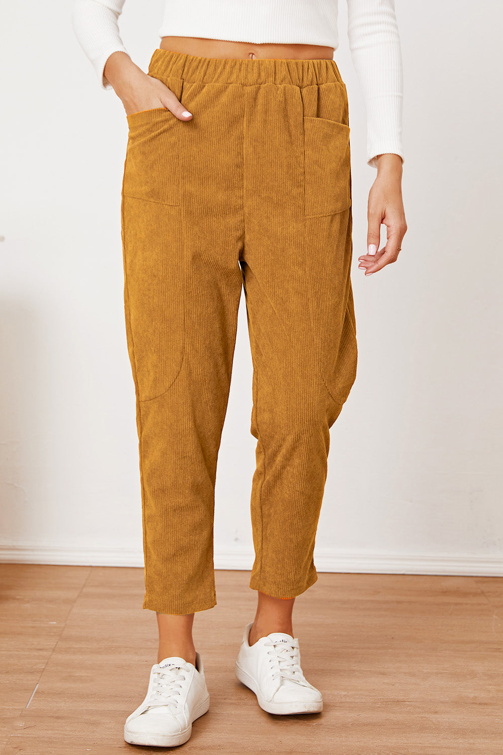 Corduroy barrel-leg utility pants in mustard with elastic waist and patch pockets.