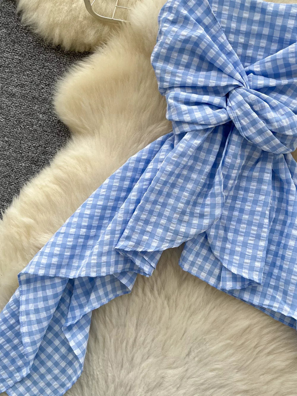 Blue gingham cami top with twisted knot detail and asymmetrical hem