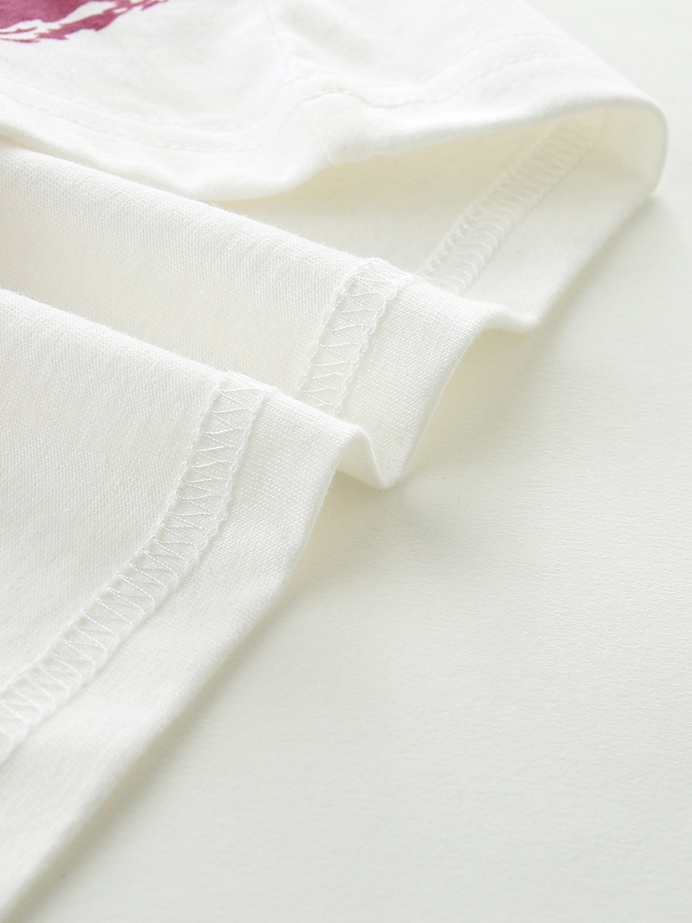 White cotton t-shirt with visible stitching detail.