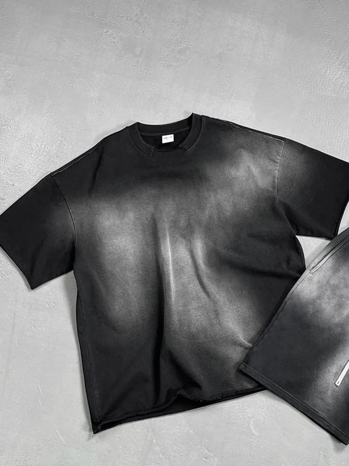 Black oversized t-shirt with faded wash and raw hem