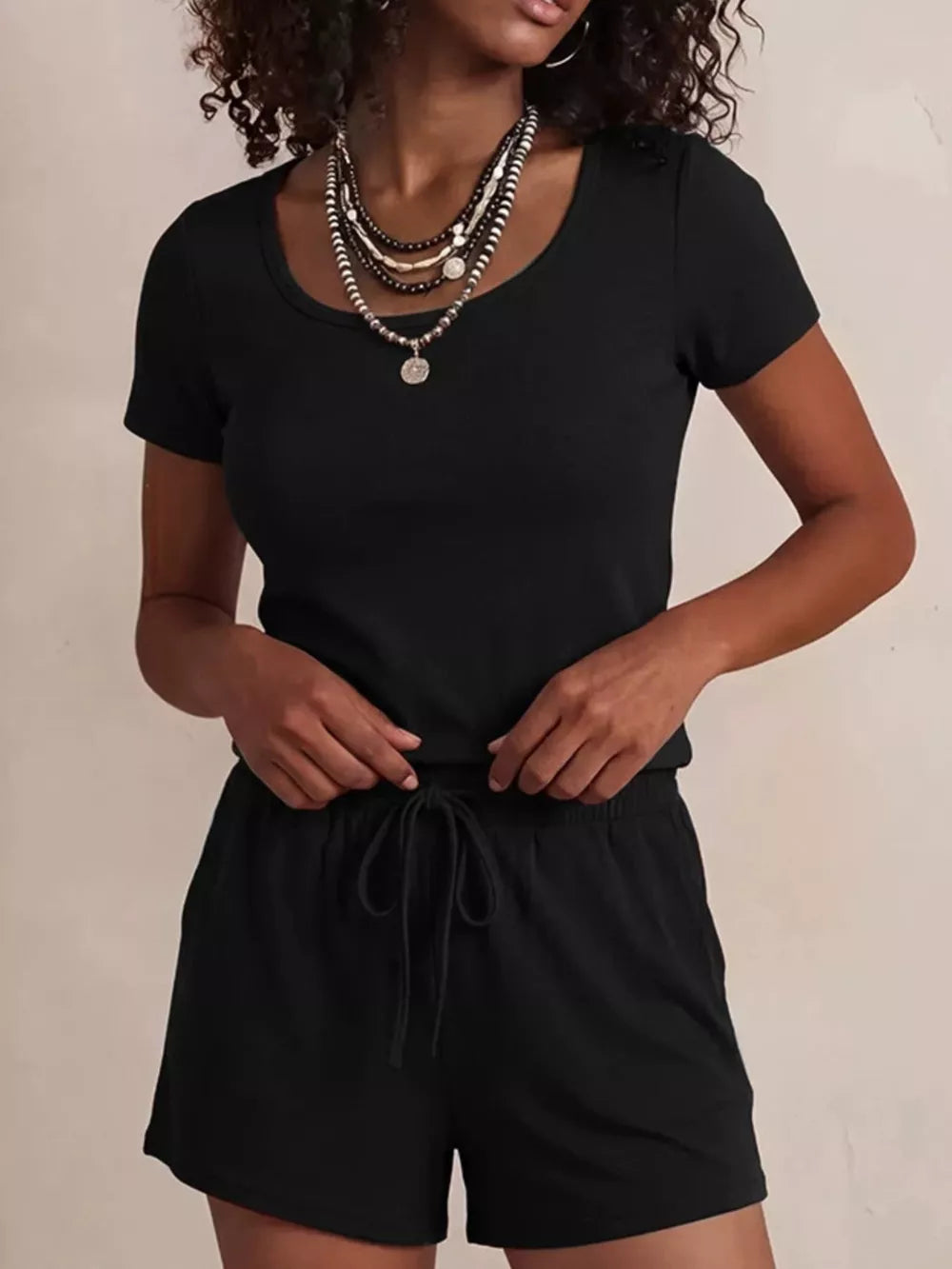 Black scoop-neck tee and drawstring shorts pajama set for women.