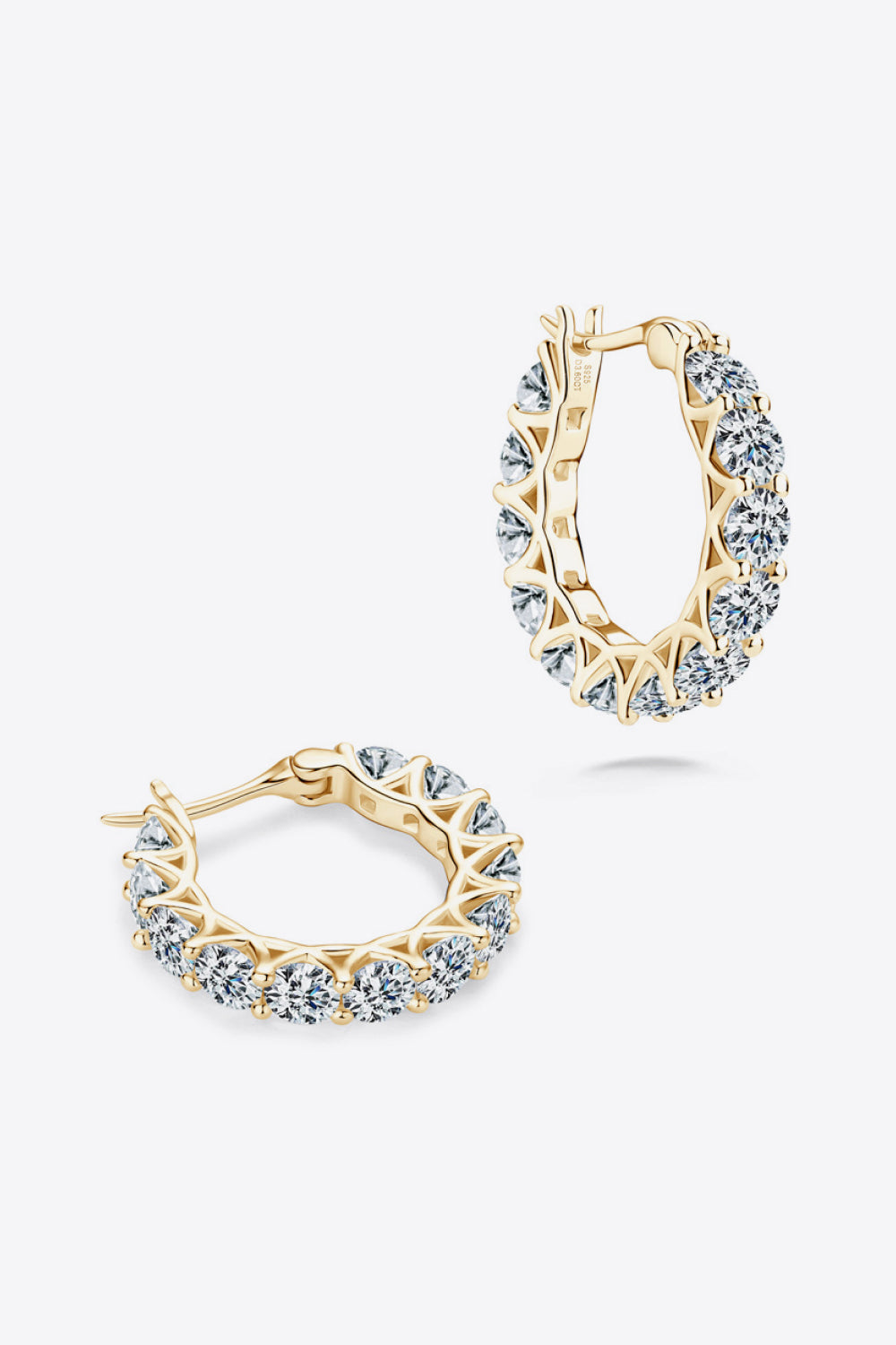 Gold moissanite pavé hoop earrings with clear stones.